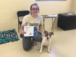 Woman and dog with training certificate for dog